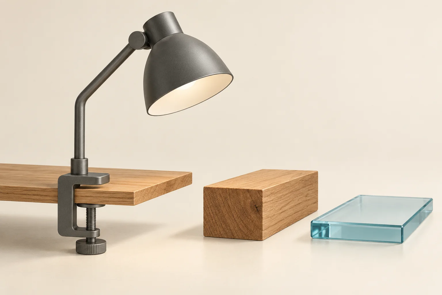 A desk-lamp clamp fits a thin wooden desktop, while a thick desktop and glass panel sit separately outside its opening.